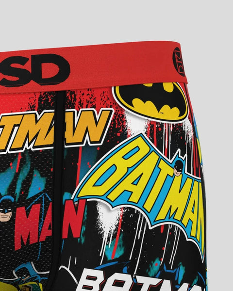 Red boxer briefs with Batman logo, comic book text, and bat symbol graphics in black, yellow, and blue.