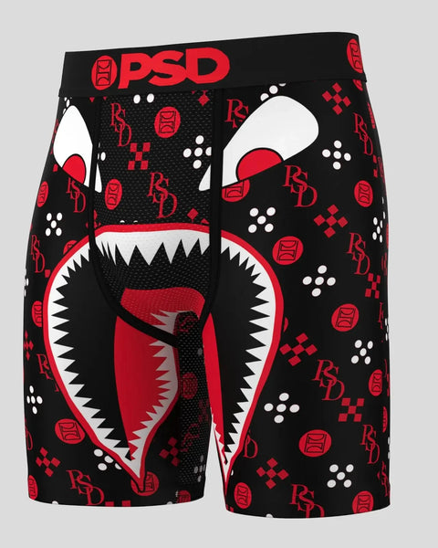 Black boxer briefs with red and white graphic face design, PSD and RBD logos, and geometric patterns throughout.