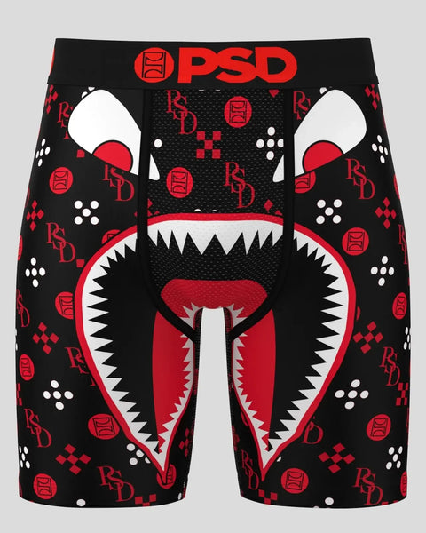 Black shorts with red and white graphic monster face design, PSD branding, and repeating logo pattern throughout.