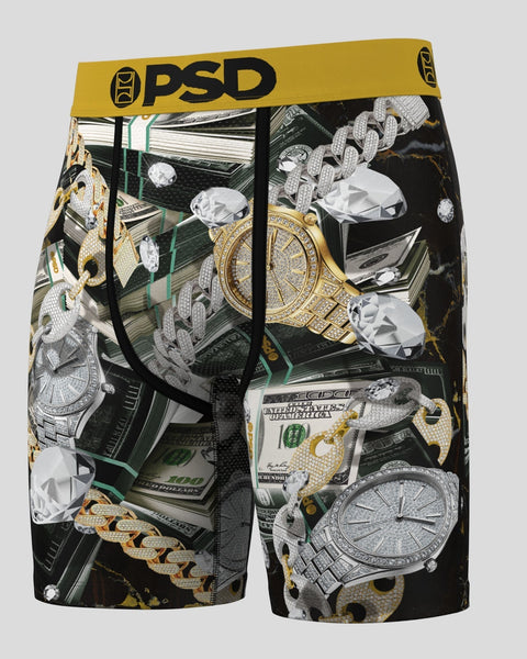 PSD boxer briefs with gold and silver diamond-encrusted watches, chains, and cash on black background.