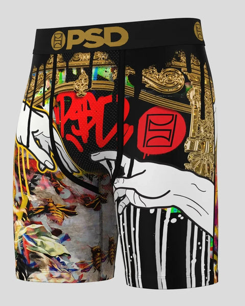 PSD black boxer briefs with gold ornate patterns, white hands, red graffiti-style text, and colorful floral details.
