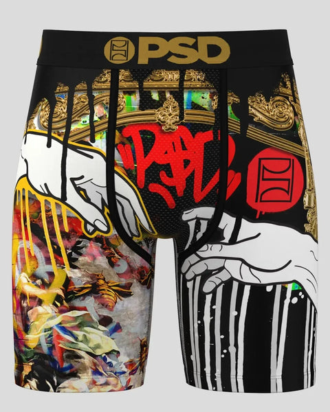 PSD boxer briefs with black waistband, gold ornamental patterns, illustrated hands, red graffiti text, and multicolored artis