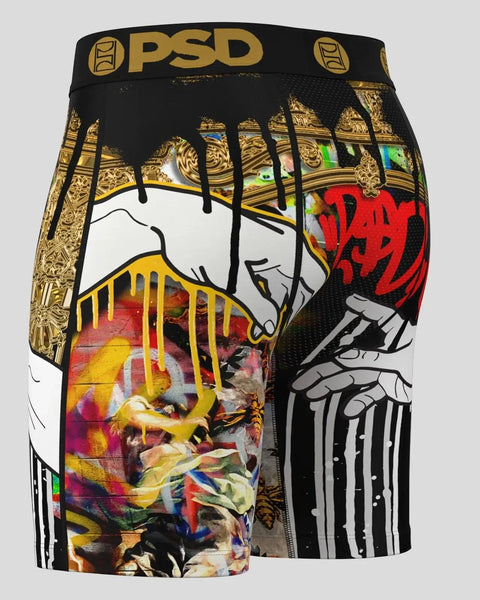 Black PSD boxer brief with gold ornamental borders, dripping paint effects, and multicolored artistic graphics on front and s