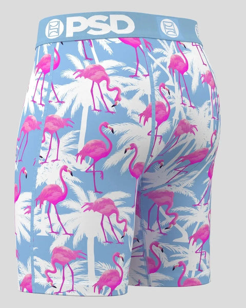 PSD boxer briefs with blue waistband featuring magenta flamingos and white palm fronds on light blue background.