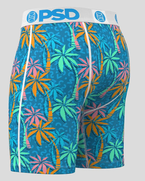 Teal boxer shorts with colorful palm leaf and bamboo print, white PSD waistband with logo.