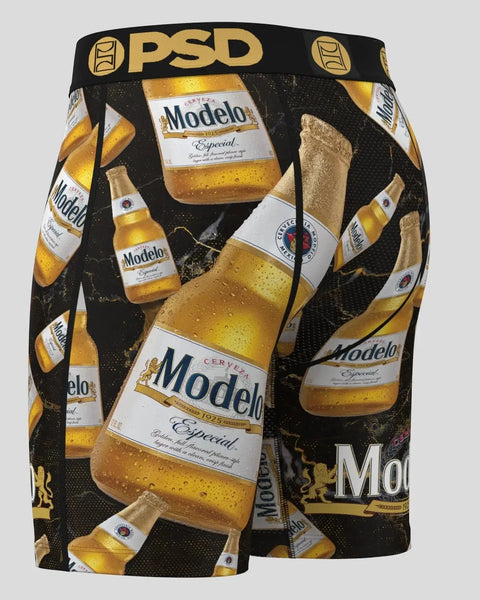 Black PSD shorts with all-over Modelo Especial beer bottle and glass print and gold waistband.