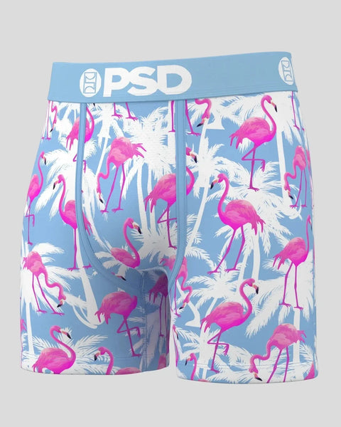 PSD boxer briefs with blue waistband featuring pink flamingos and white palm fronds on light blue background.