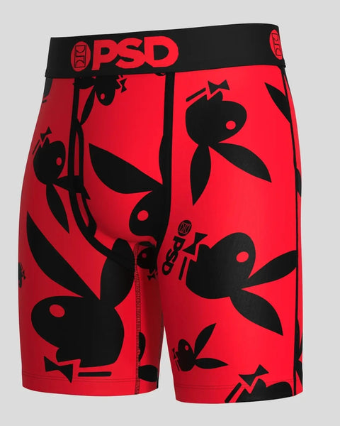 Red shorts with black Playboy bunny logo repeated all over, featuring PSD waistband and front zipper.
