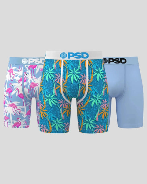 Three PSD boxer briefs in flamingo print, tropical leaf print, and solid blue with branded waistbands.