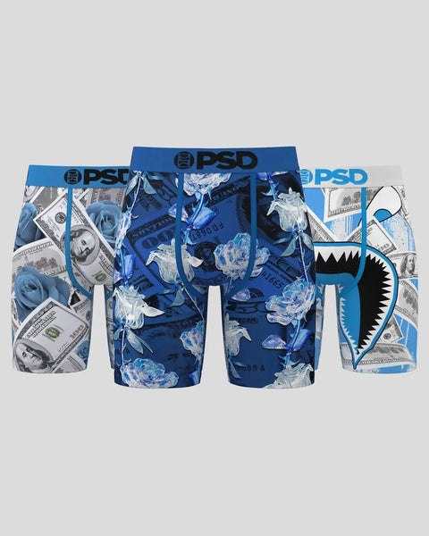 Three PSD boxer briefs with blue waistbands in dollar bill, floral, and shark mouth print patterns.