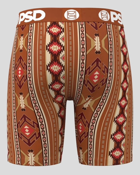 Brown shorts with geometric Aztec-inspired pattern in red, cream, and tan stripes with diamond and arrow motifs.