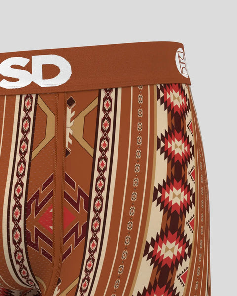 Brown boxer briefs with geometric Aztec-inspired patterns in cream, red, and dark brown stripes and diamond shapes.
