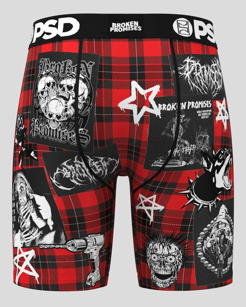 Red and black plaid boxer briefs with Broken Promises branding, skull graphics, and white star designs throughout.