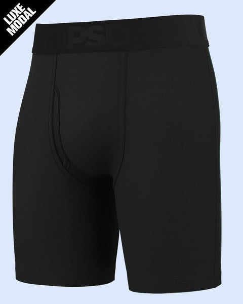 Black modal boxer briefs with elastic waistband and contrast stitching detail on light blue background.