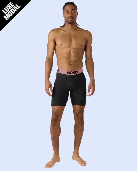 Black modal boxer briefs with rose gold waistband and PSD logo on male model.