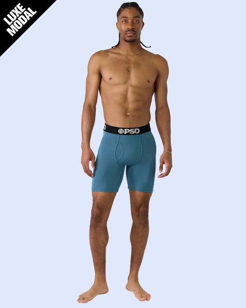 Man wearing teal modal boxer briefs with black PSD waistband.
