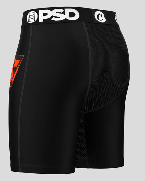 Black shorts with PSD waistband, mesh side panels, and red ransom note graphic on left leg.