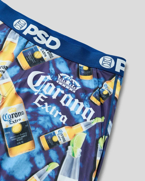 Corona Extra beer bottles and lime wedges printed on blue tie-dye boxer briefs with PSD waistband.