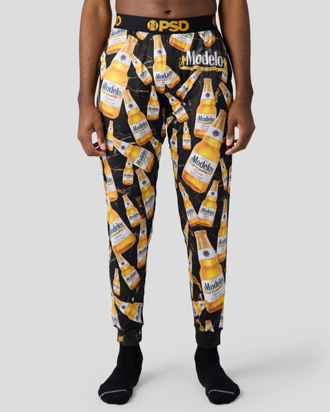 Black joggers with all-over Modelo beer bottle print and PSD waistband.