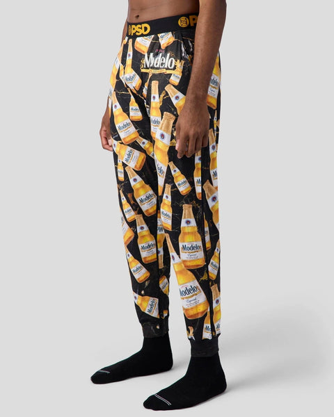 Black lounge pants with repeated Modelo beer bottle print and PSD waistband.