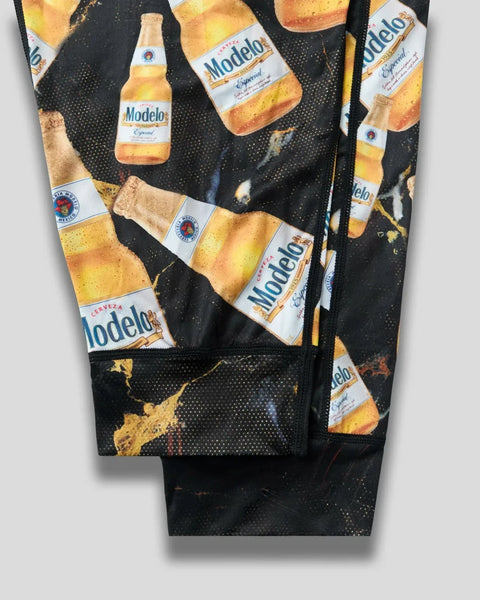 Black leggings with Modelo beer bottle and glass print pattern throughout.