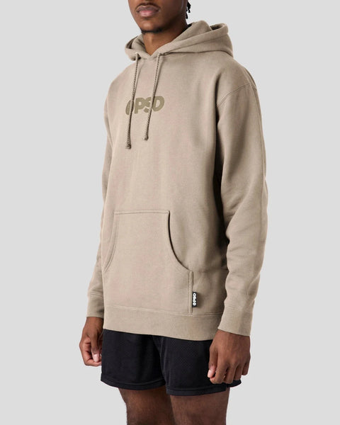 Beige hoodie with PSD logo on chest, drawstring hood, and front pocket, worn with black shorts.