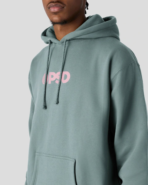 Dusty sage hoodie with pink PSD logo on chest, drawstring hood, and front kangaroo pocket.