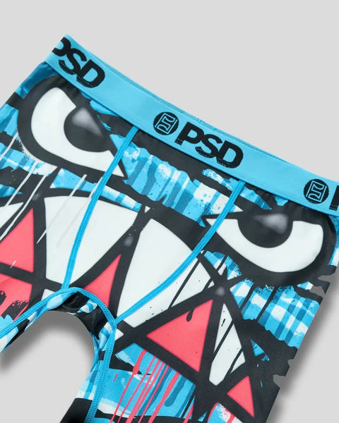 PSD underwear with blue waistband featuring black, white, and red geometric face design with dripping pattern.