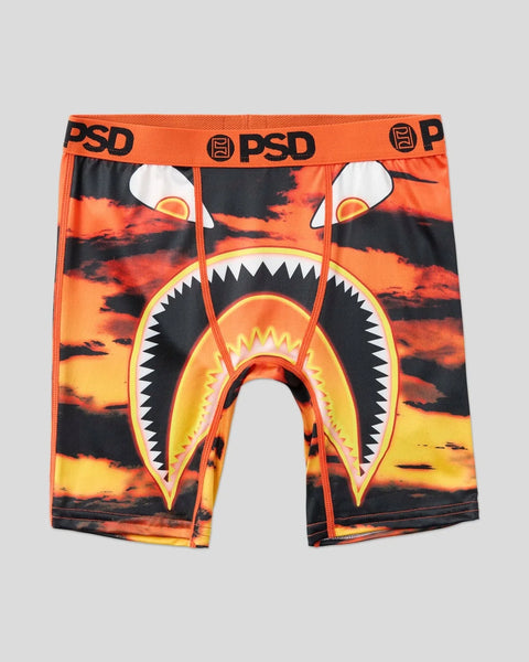 Orange and black boxer briefs with shark mouth graphic and fiery sky pattern, PSD waistband visible.