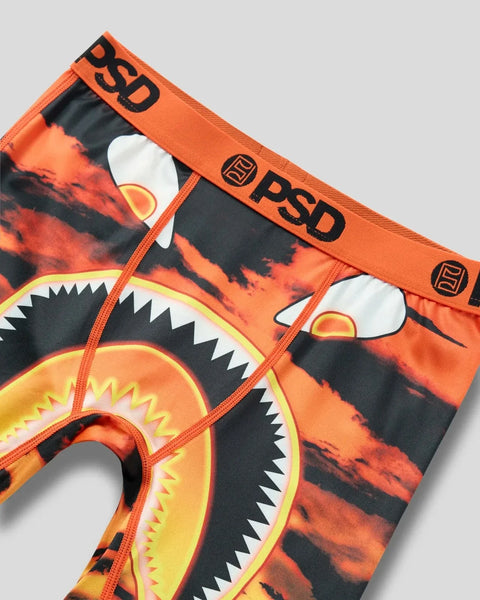 PSD underwear with orange waistband featuring fire and monster mouth graphic design on black and orange fabric.