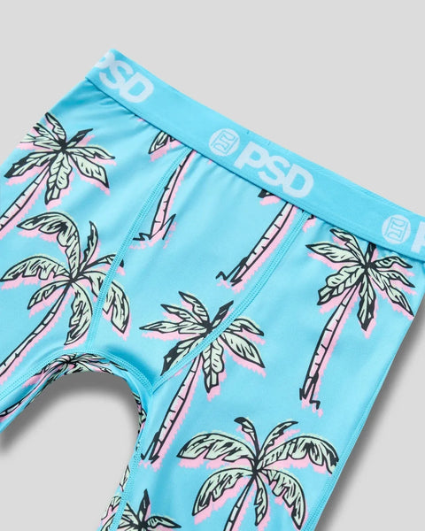 Bright blue boxer briefs with repeating palm tree pattern in pink, black, and cream, featuring PSD waistband.