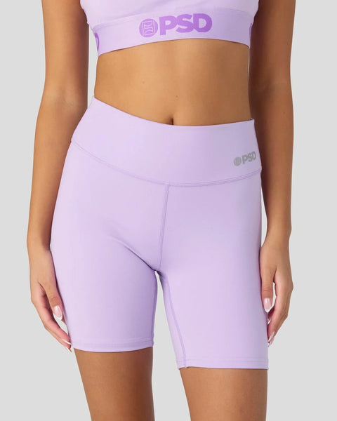 Lavender sports bra and biker shorts set with PSD branding on elastic waistbands.