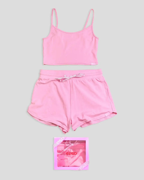 Bubblegum pink cami top with matching shorts and branded packaging, displayed flat on gray background.