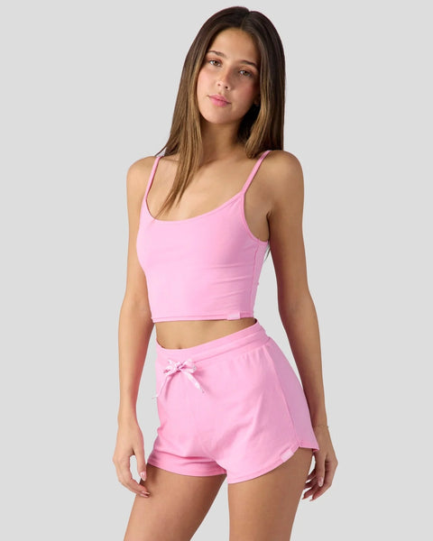 Bubblegum pink cami sleep set with thin straps, cropped top, and drawstring shorts on model.
