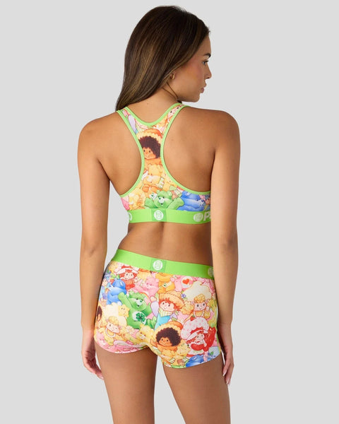 Neon green sports bra and shorts set with Strawberry Shortcake and Care Bears character print throughout.