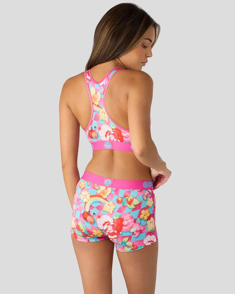 Pink racerback sports bra and shorts set with Strawberry Shortcake and Care Bears characters and rainbow print.