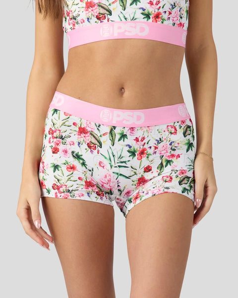 Woman wearing floral print bra and boyshort underwear with pink elastic waistband.