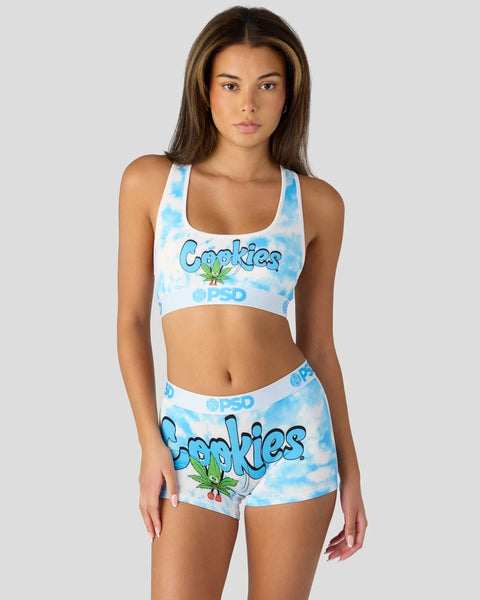 Blue tie-dye two-piece set with "Cookies" text and leaf graphic on sports bra and shorts.