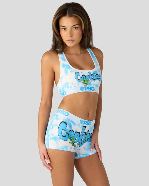 Woman wearing blue and white tie-dye sports bra and matching shorts with 