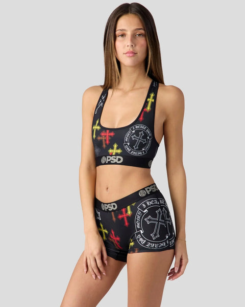 Black sports bra and shorts set with red and yellow cross graphics and circular logo print.