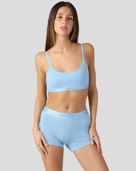Light blue sports bra and matching boy shorts with logo waistband.