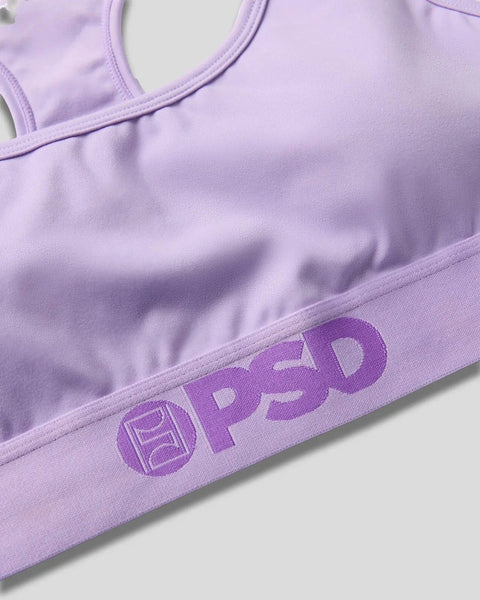 Lavender sports bra with racerback straps and ProLuxe branding on elastic underband.
