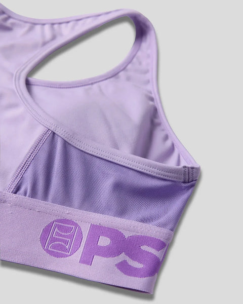 Lavender sports bra with racerback straps and ProLuxe logo band, showing front detail and textured fabric construction.