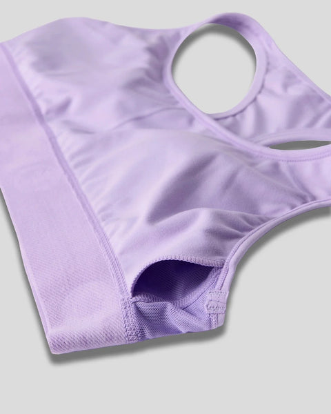 Lavender-colored sleeveless garment with shoulder cutouts and textured fabric shown flat against a neutral background.
