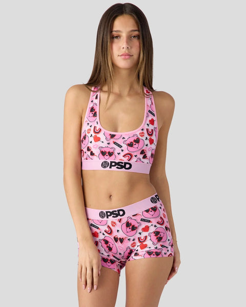 Pink sports bra and shorts set with Care Bears Love Bear print and PSD branding.