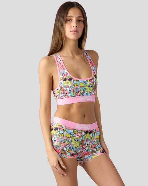 Woman wearing SpongeBob SquarePants colorful character print sports bra and matching shorts with pink trim.
