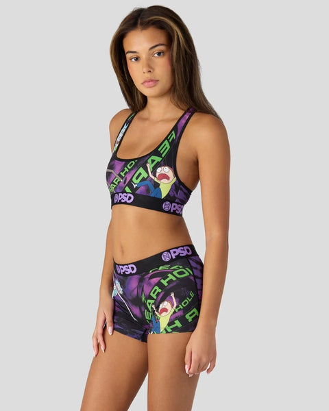 Woman wearing Rick and Morty Fear Hole sports bra and shorts set in purple, black, and green with character graphics and PSD 