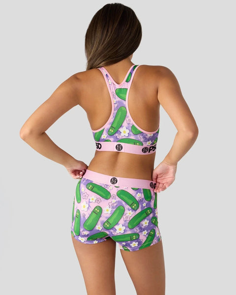 Women's sports bra and shorts set with purple background featuring green pickle and character print patterns.