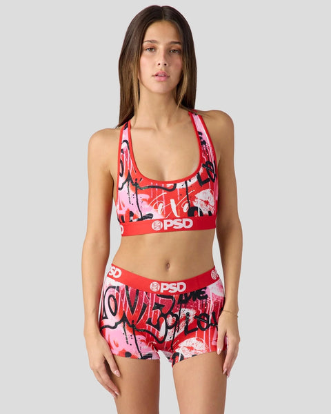 Red and pink graffiti print sports bra and shorts set with PSD branding and racer back straps.