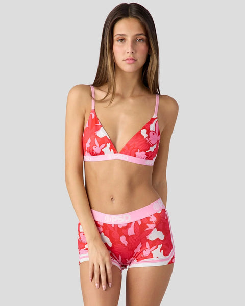 Woman wearing red and pink camouflage-patterned bikini top and shorts with pink trim.